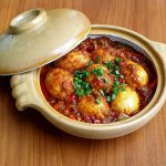 Studio maato present kinema egg curry in a custom made Donabe - Clay pot dish